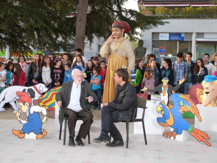 Ramon Folch i Camarasa i Espartac Peran, envoltats d'alguns dels personatges creats per Josep M. Folch i Torres.