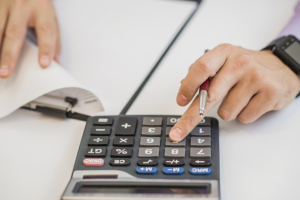 close-up-businessman-calculating-invoices-using-calculator-redim-w740-h1400.jpg